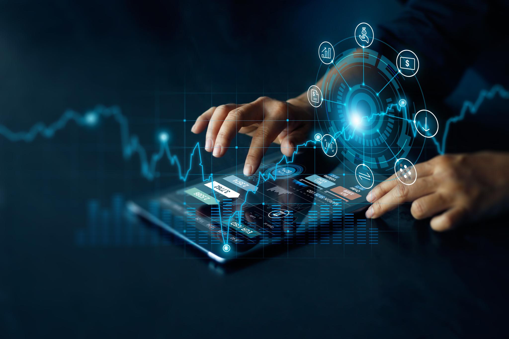 Hands using a tablet with digital finance interface overlays