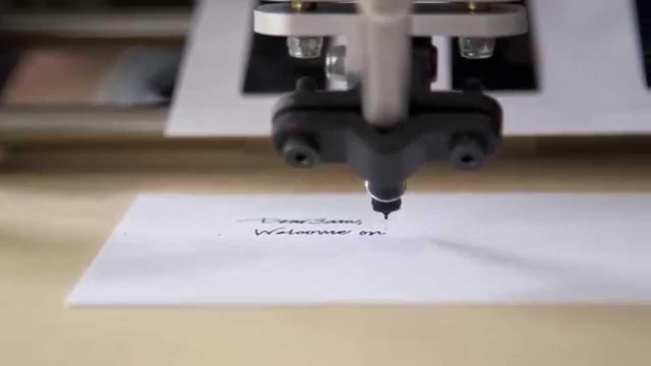 Robotic pen plotter writing a handwritten-style note on a card
