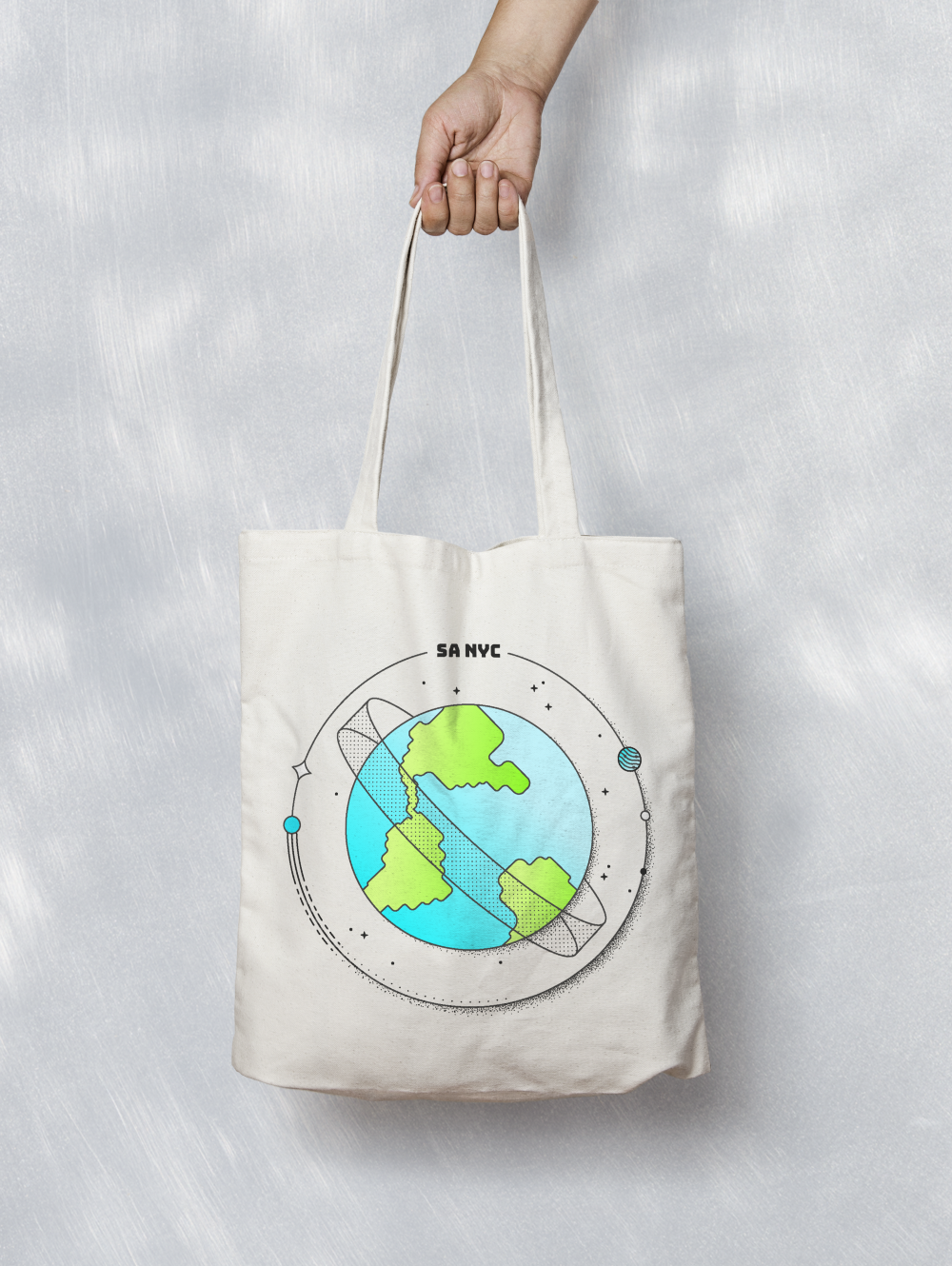 Canvas tote bag printed with the SA NYC orbiting-planet illustration