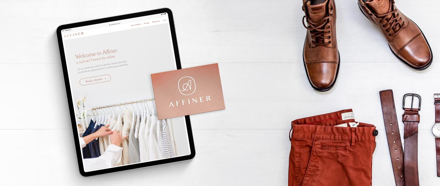 Tablet with Affiner website beside shoes, pants, belt, and card