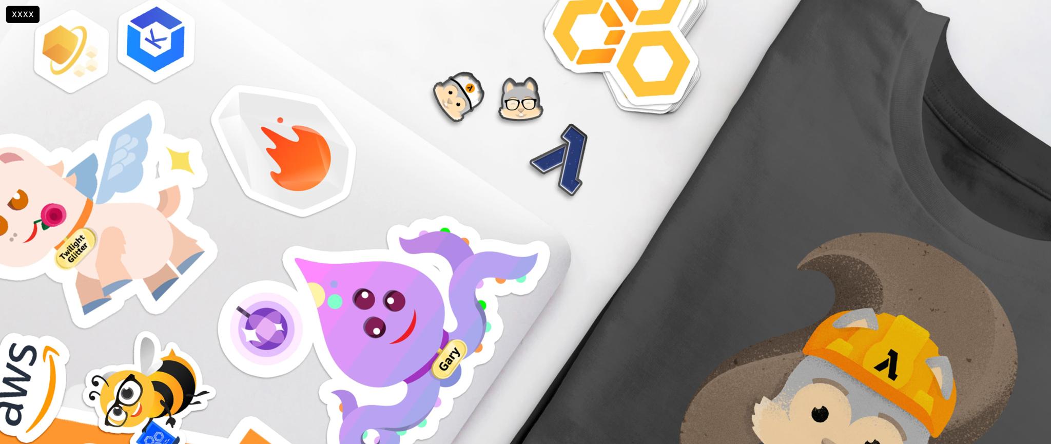 AWS character stickers spread on a white surface beside a dark printed T-shirt