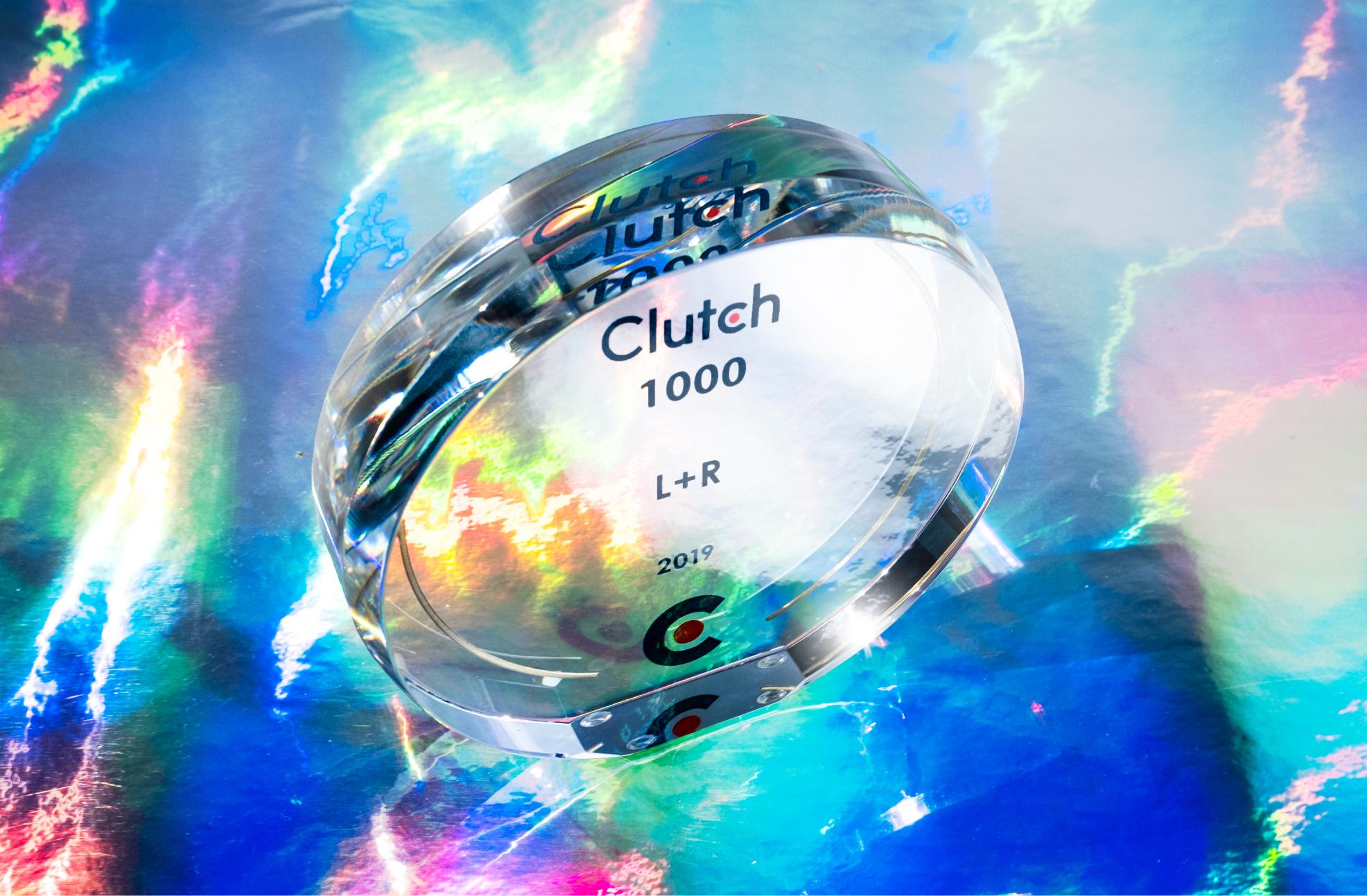 Glass Clutch 1000 award engraved for L+R 2019 on an iridescent surface