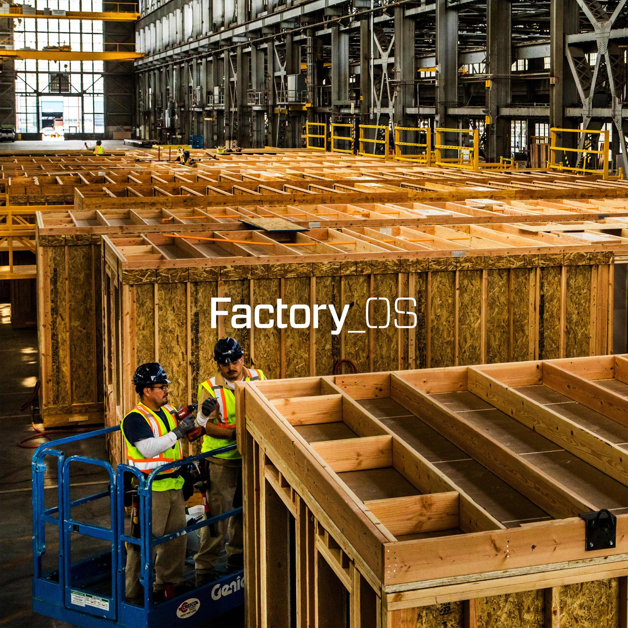 Factory_OS workers on a lift building timber-framed housing modules inside the factory