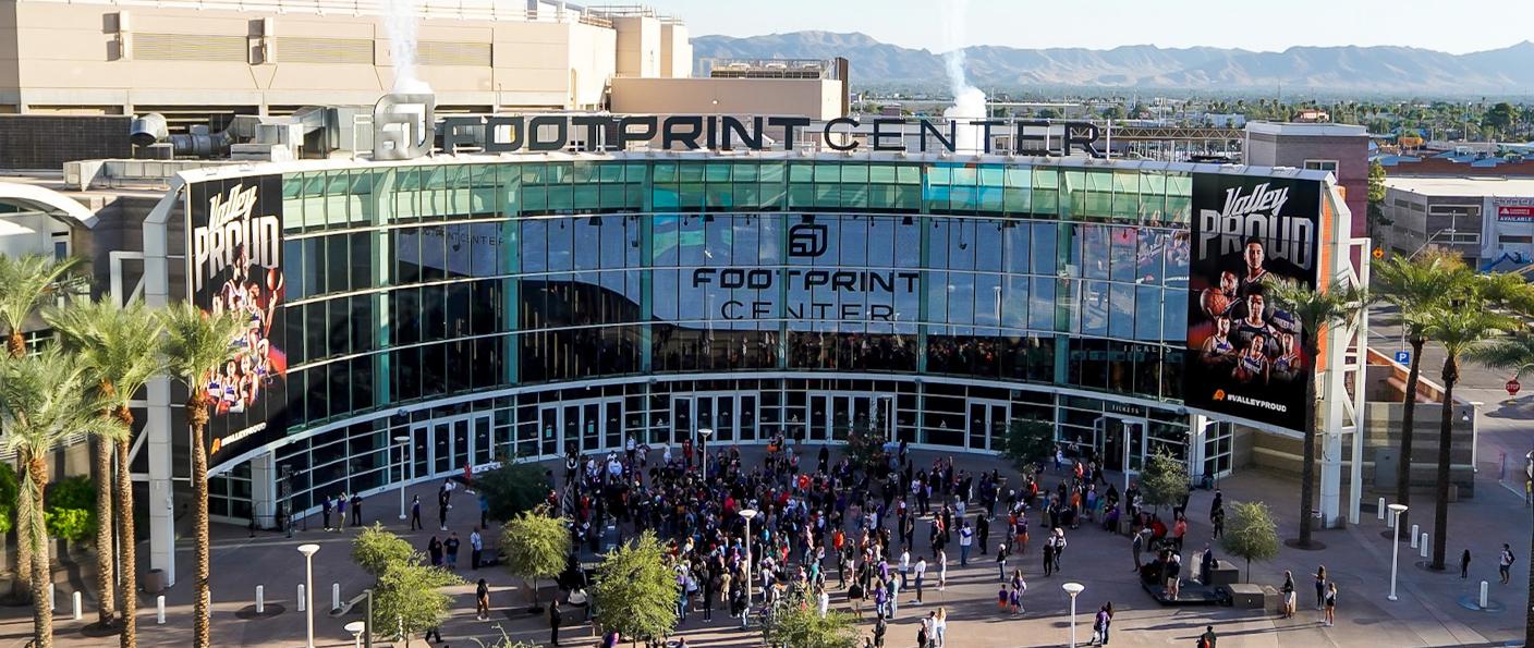 Footprint Center arena entrance with crowds outside and Valley Proud banners