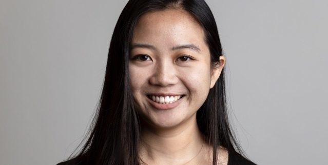 Portrait of Grace Kim, L+R Brooklyn strategy intern, against a gray studio backdrop