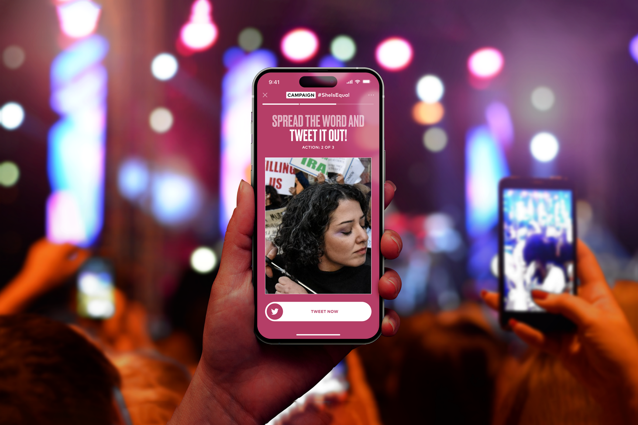 Hand holding a phone with a campaign screen at a concert