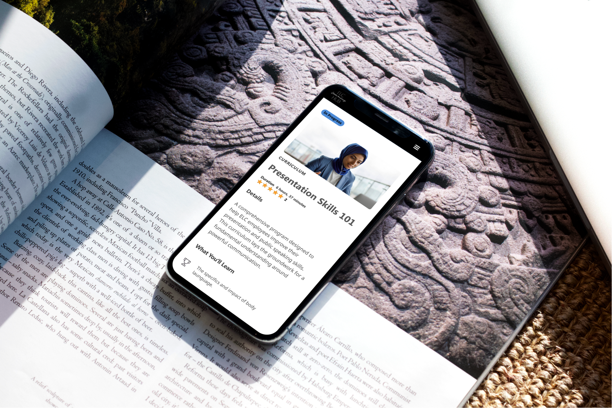 Phone on an open book showing a Presentation Skills 101 course page