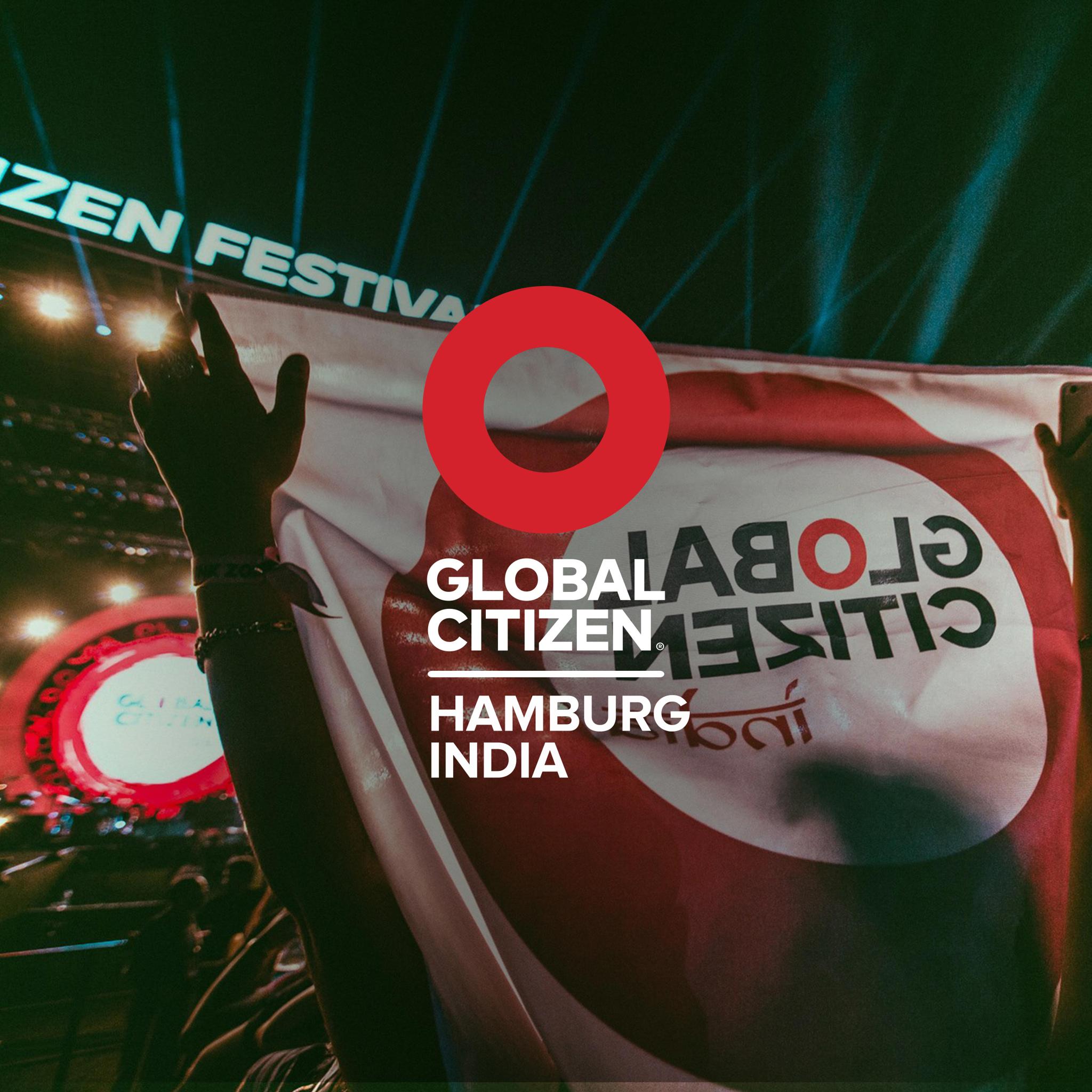 Global Citizen Hamburg India lockup over a Global Citizen Festival banner held up by the crowd