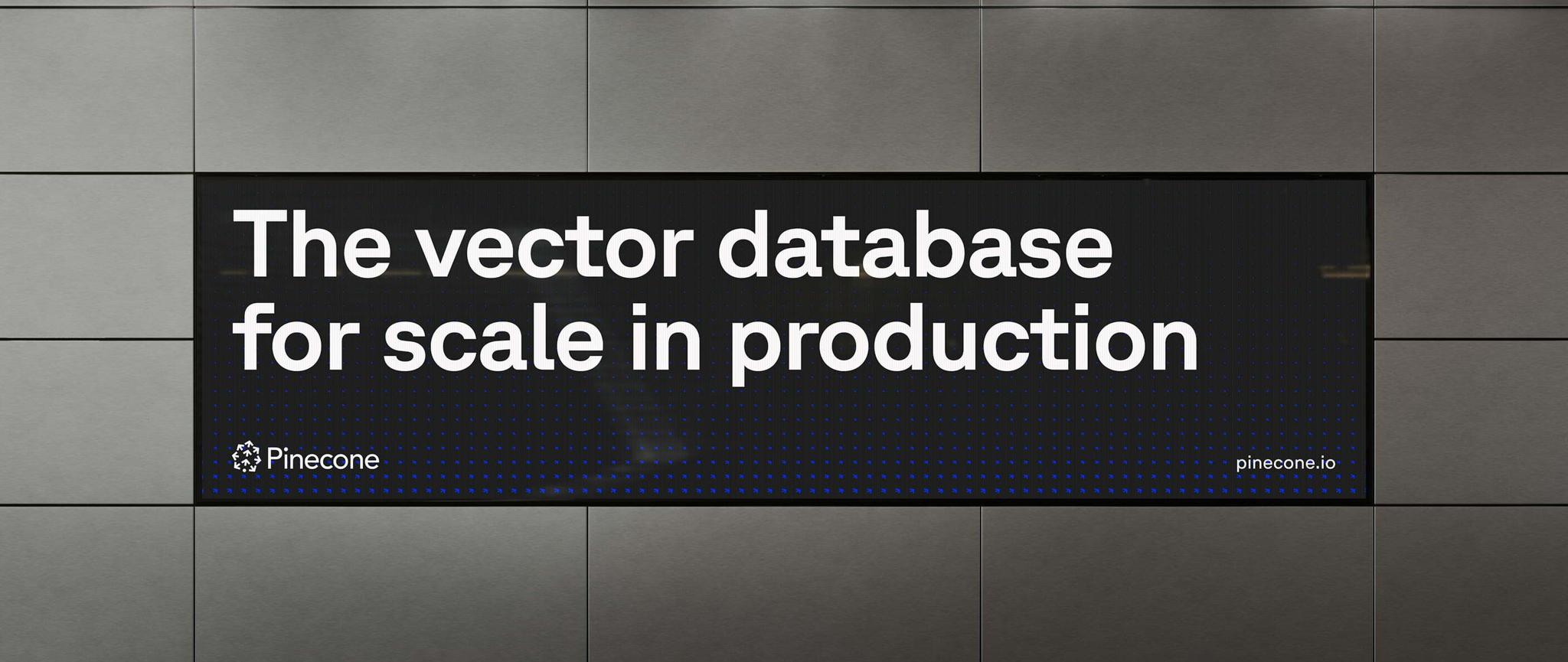 Pinecone billboard reading "The vector database for scale in production" on a metal-panelled wall.