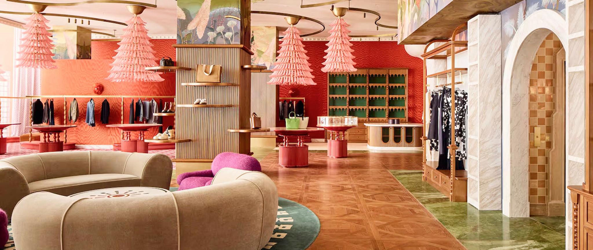 Wide view of luxury retail interior with seating, displays, and arched entry