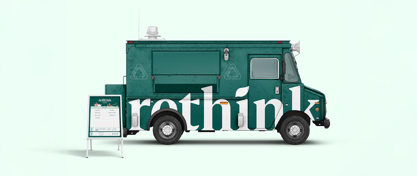Green rethink food truck with a sidewalk menu board