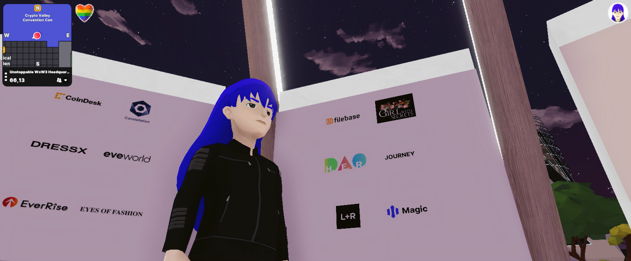 Blue-haired avatar standing before a sponsor logo wall in a virtual venue