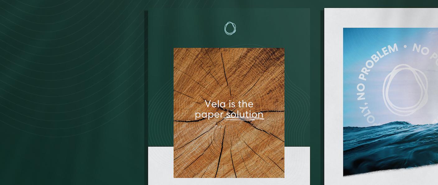 Vela posters on dark green: a wood cross-section reading "Vela is the paper solution" beside an ocean poster