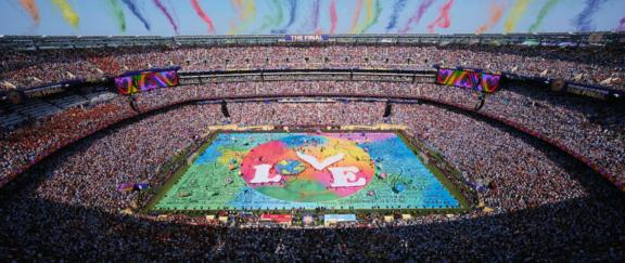 Desktop BIL 01 Packed stadium with a colorful Believe in Love display on the field.