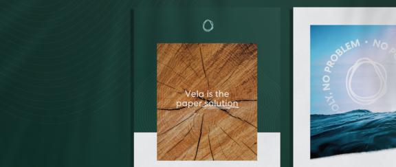 Vela D Cover Green paper packaging mockup with wood grain insert reading "Vela is the paper solution"