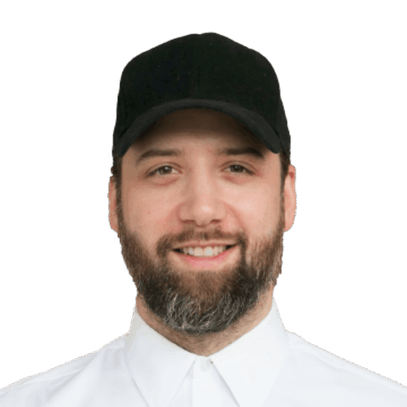 Alex L min Bearded man wearing a black cap and white buttoned shirt on a green background
