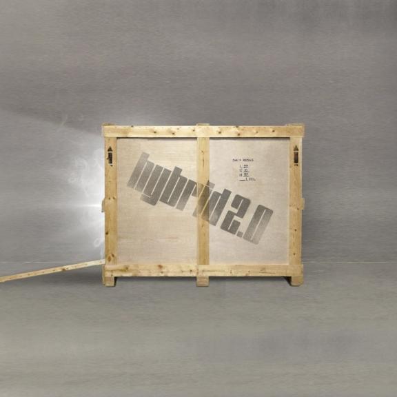 Wooden shipping crate with stenciled text and a loose plank on gray floor