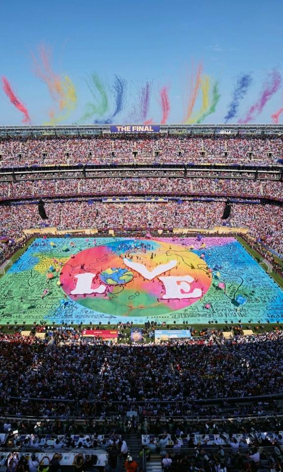 Mobile BIL 01 Packed stadium with a colorful Believe in Love display on the field.