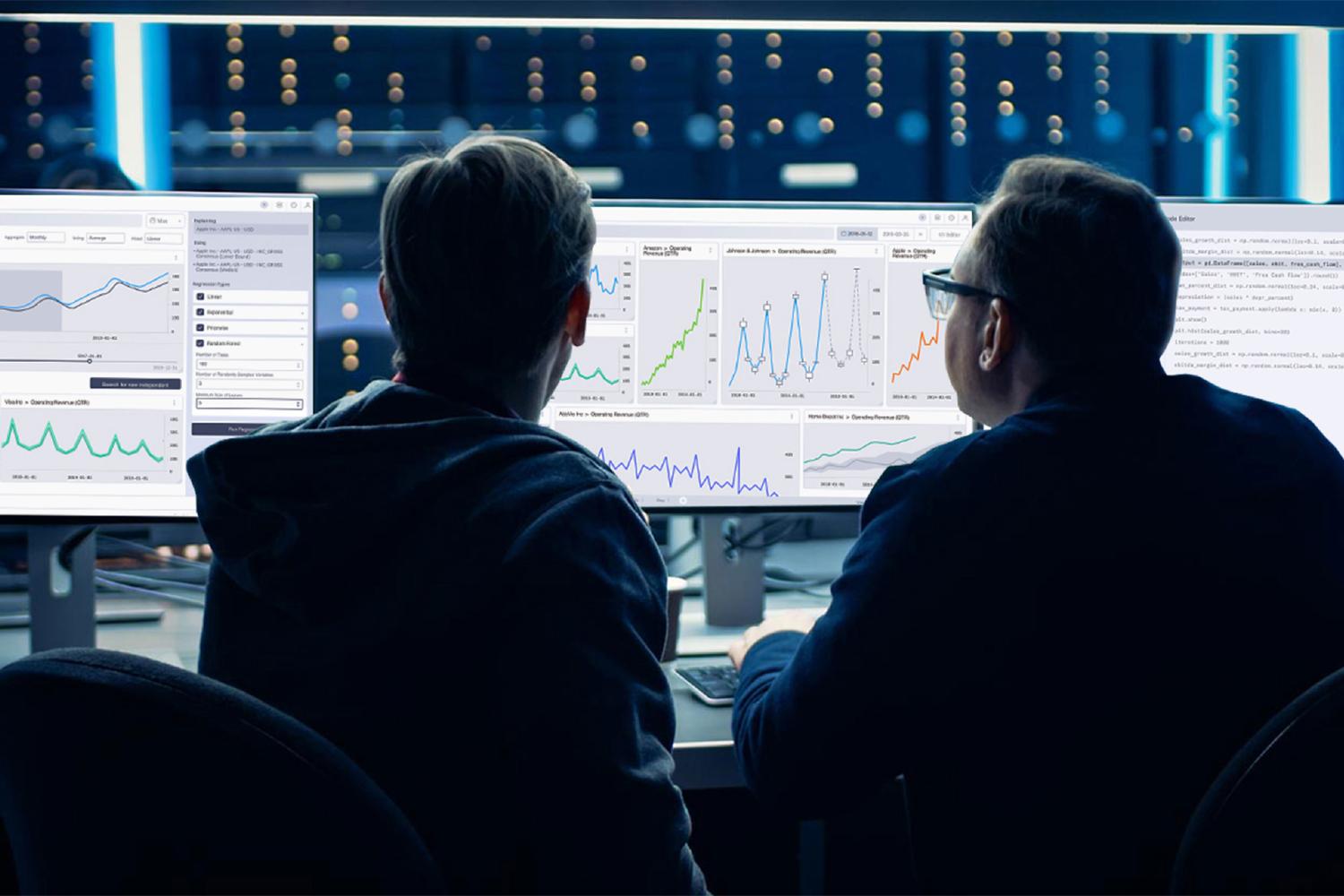Two analysts reviewing Datavore revenue dashboards across multiple monitors