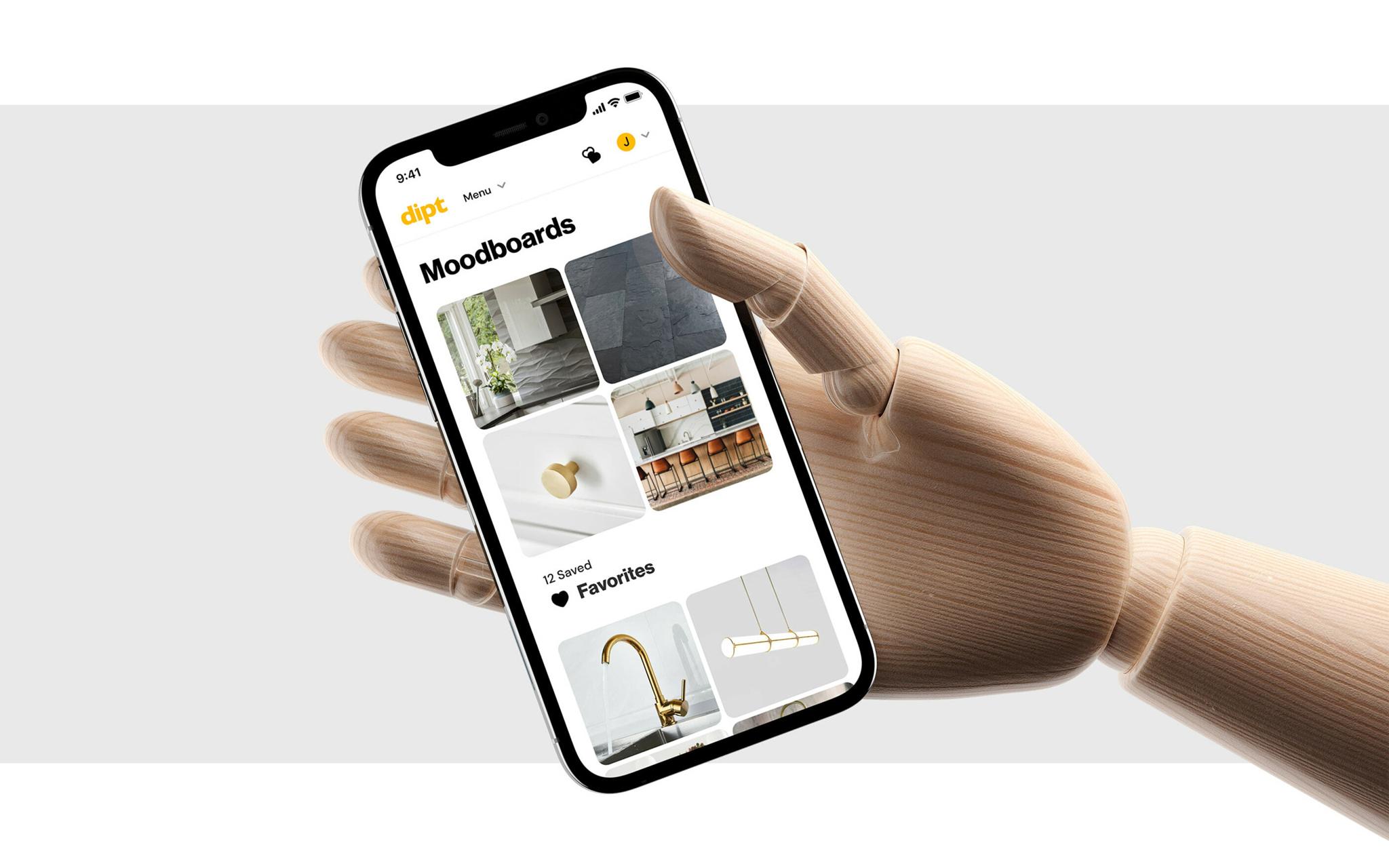 Wooden mannequin hand holding a phone showing Dipt moodboards and favorites