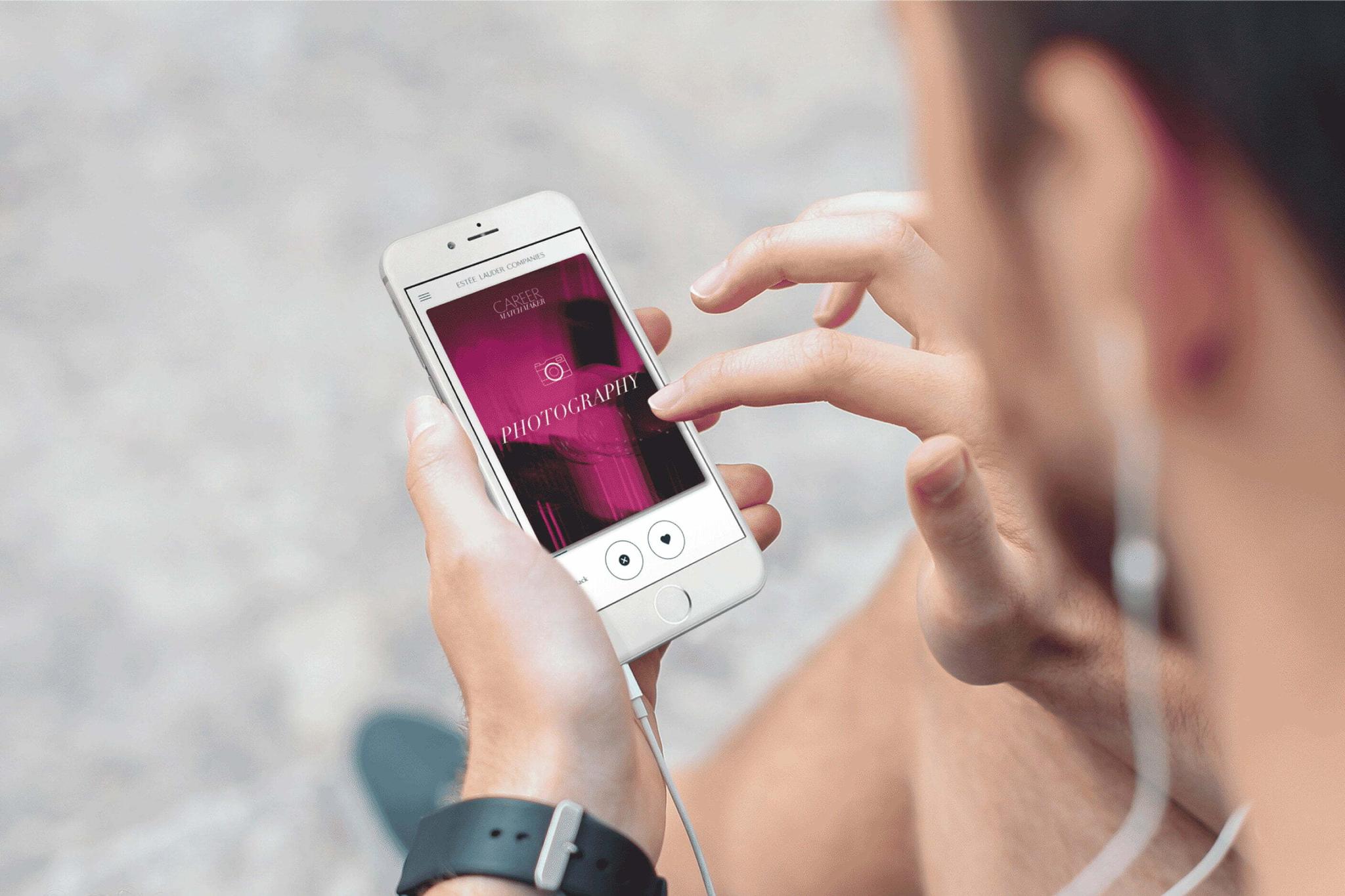 Hand holding a phone running the Estee Lauder Career Matchmaker app on a Photography card