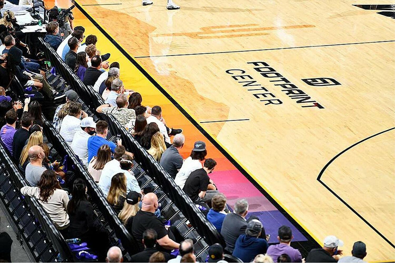 Fans seated courtside at Footprint Center during a basketball game