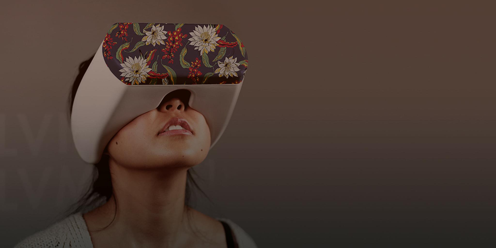 Person wearing a floral-patterned virtual reality headset in a dim scene