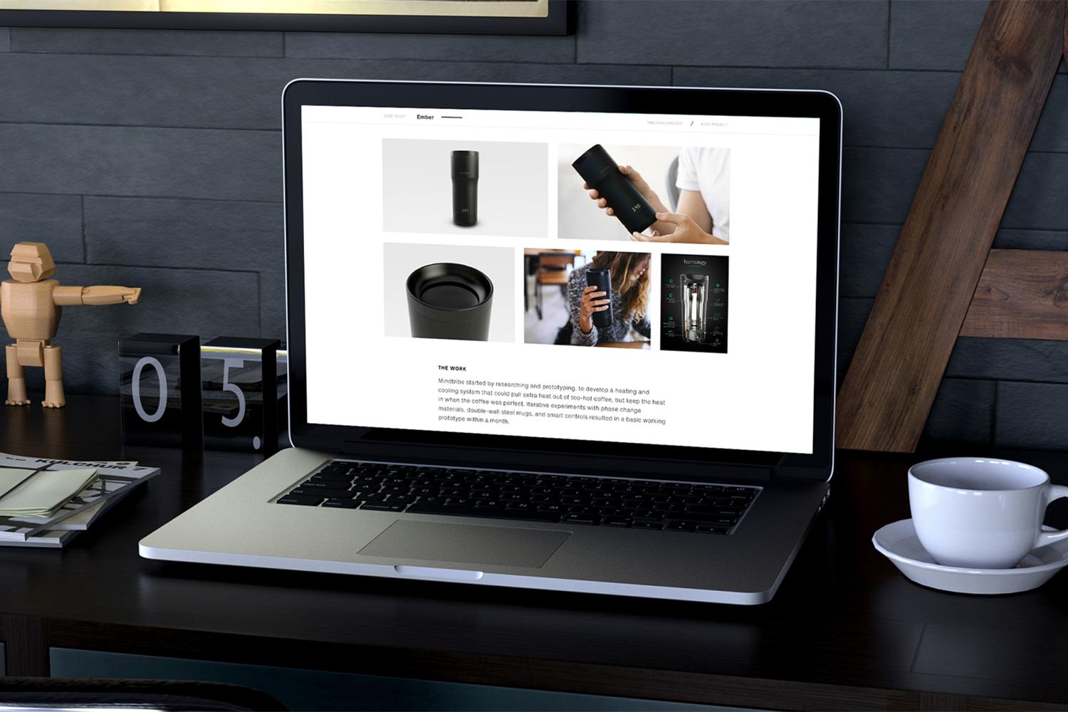 Laptop on a desk showing the Mindtribe case study page for the Ember mug