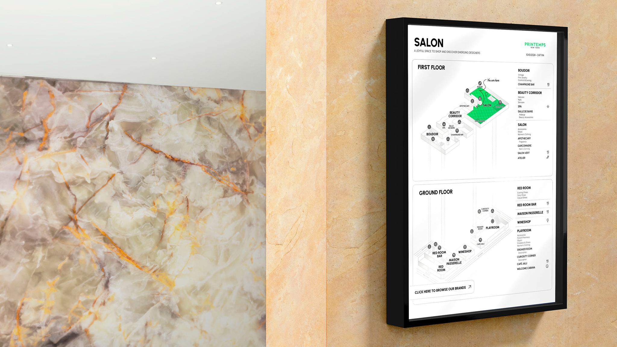 Wall-mounted SALON directory map beside a marble wall