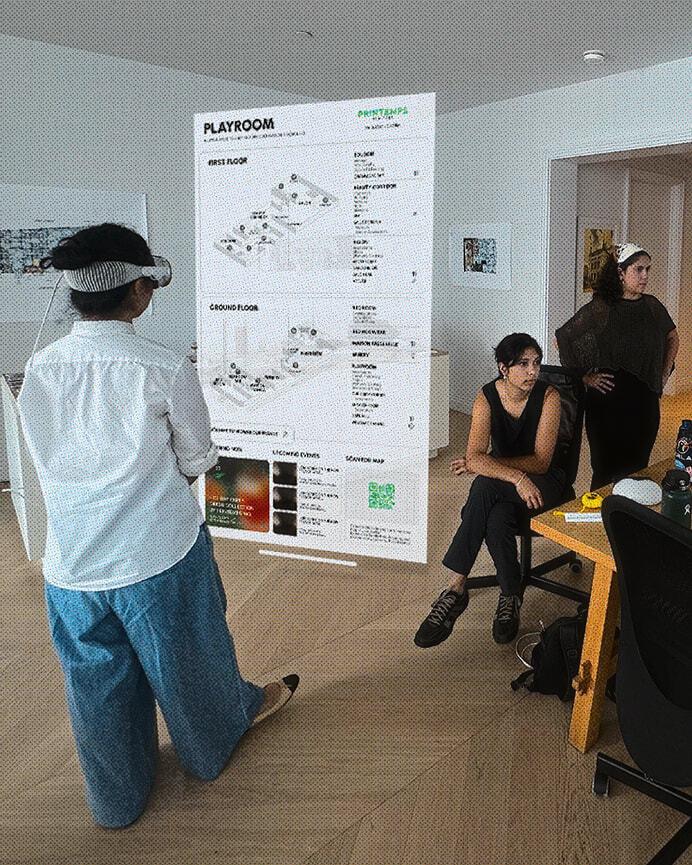 Person wearing a mixed reality headset viewing a floating Playroom map in an office.