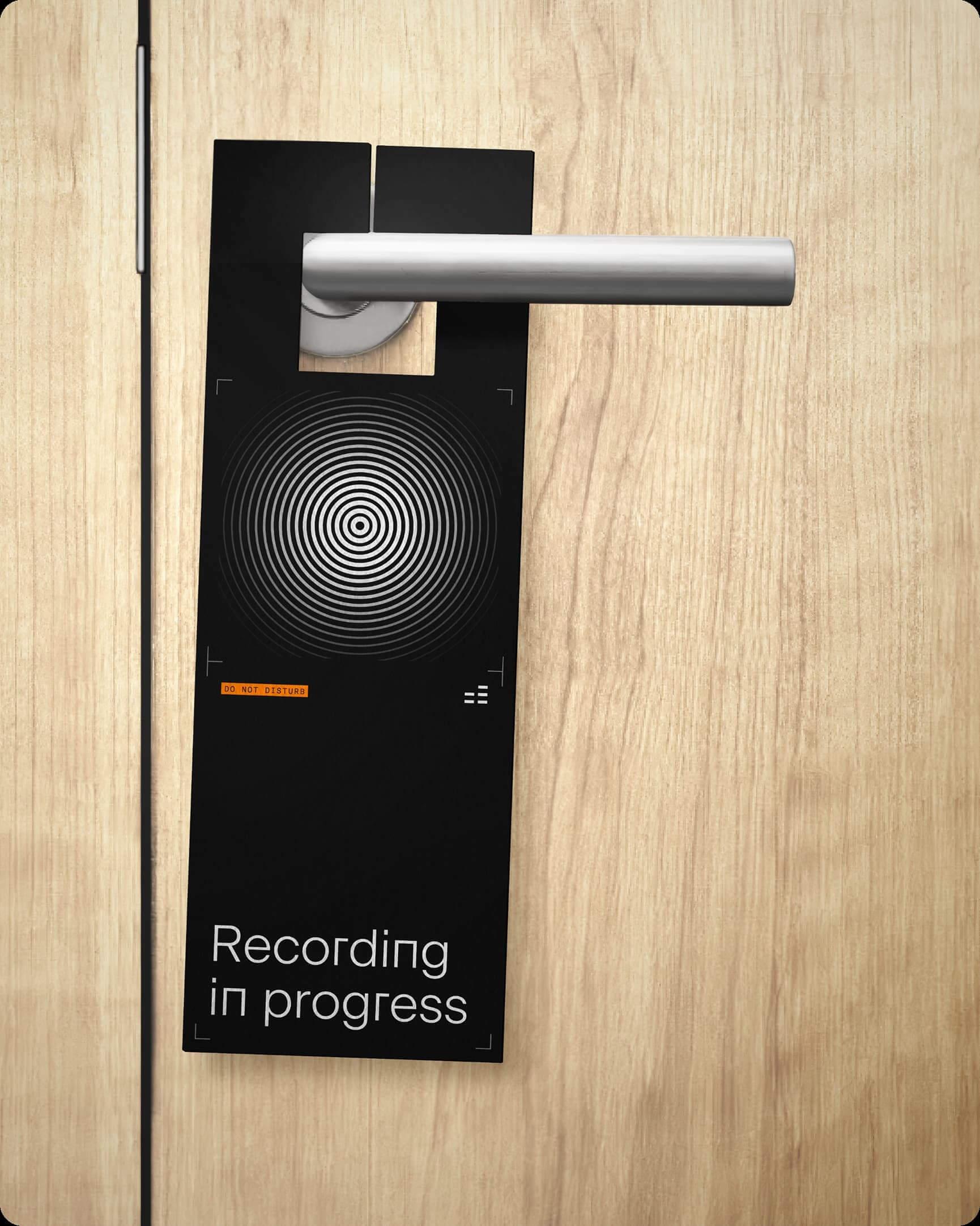 Cakewalk door hanger reading "Recording in progress" on a wooden door