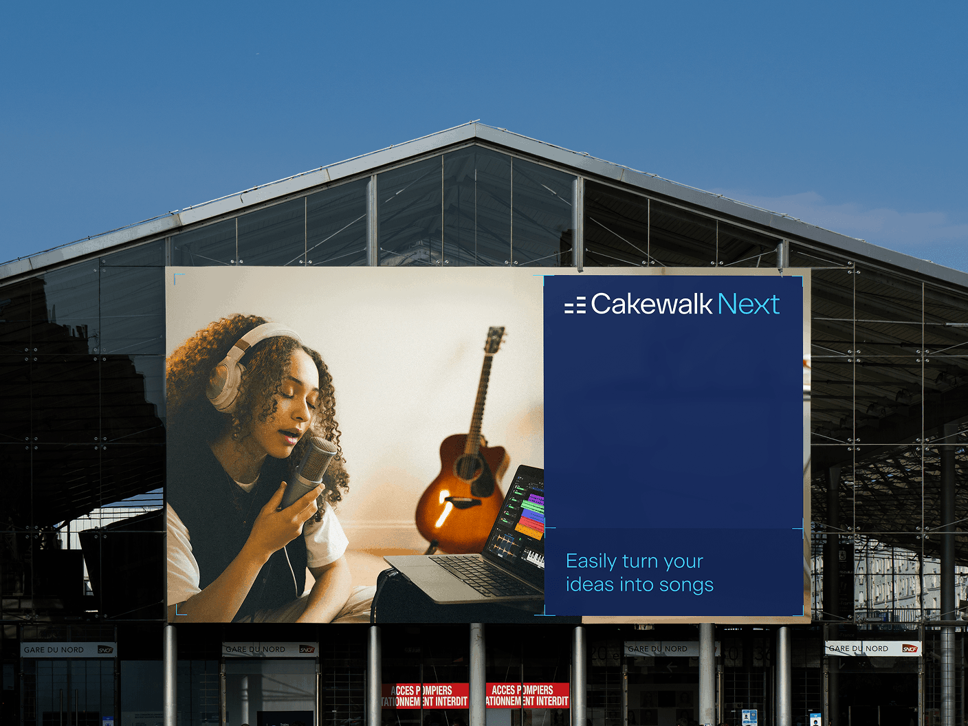 Outdoor Cakewalk Next billboard reading "Easily turn your ideas into songs" beside a singer