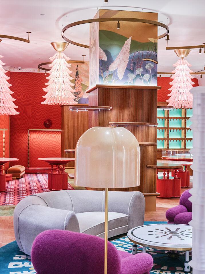 Colorful retail lounge with sculptural pink chandeliers and plush seating