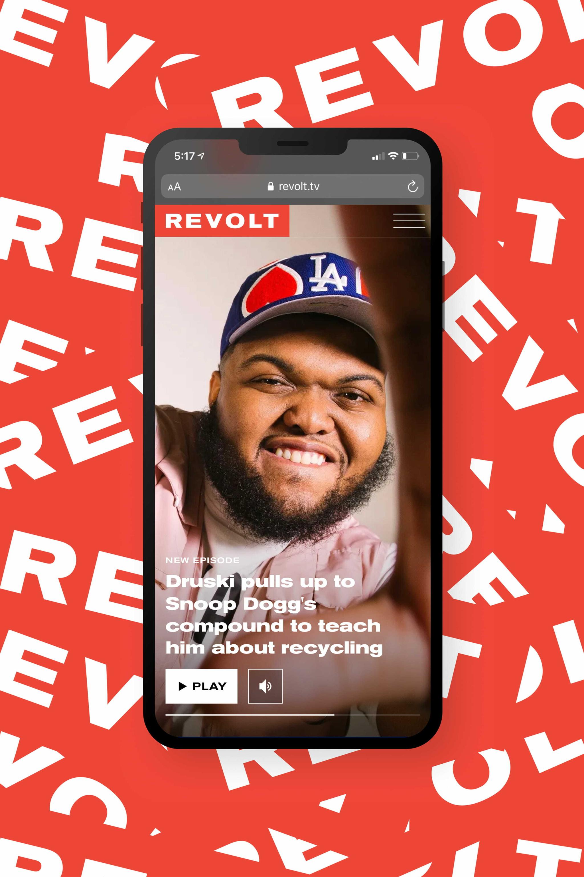 Smartphone showing REVOLT story about Druski on a red branded background