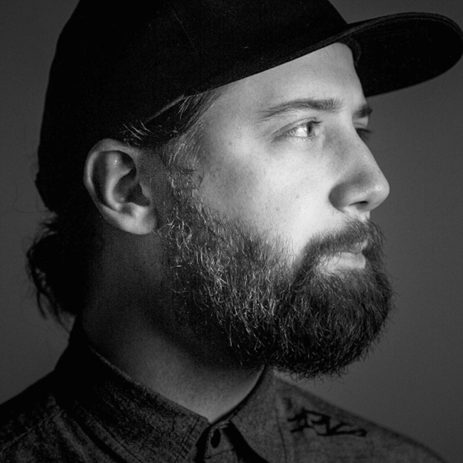 Black-and-white profile portrait of Alex Levin