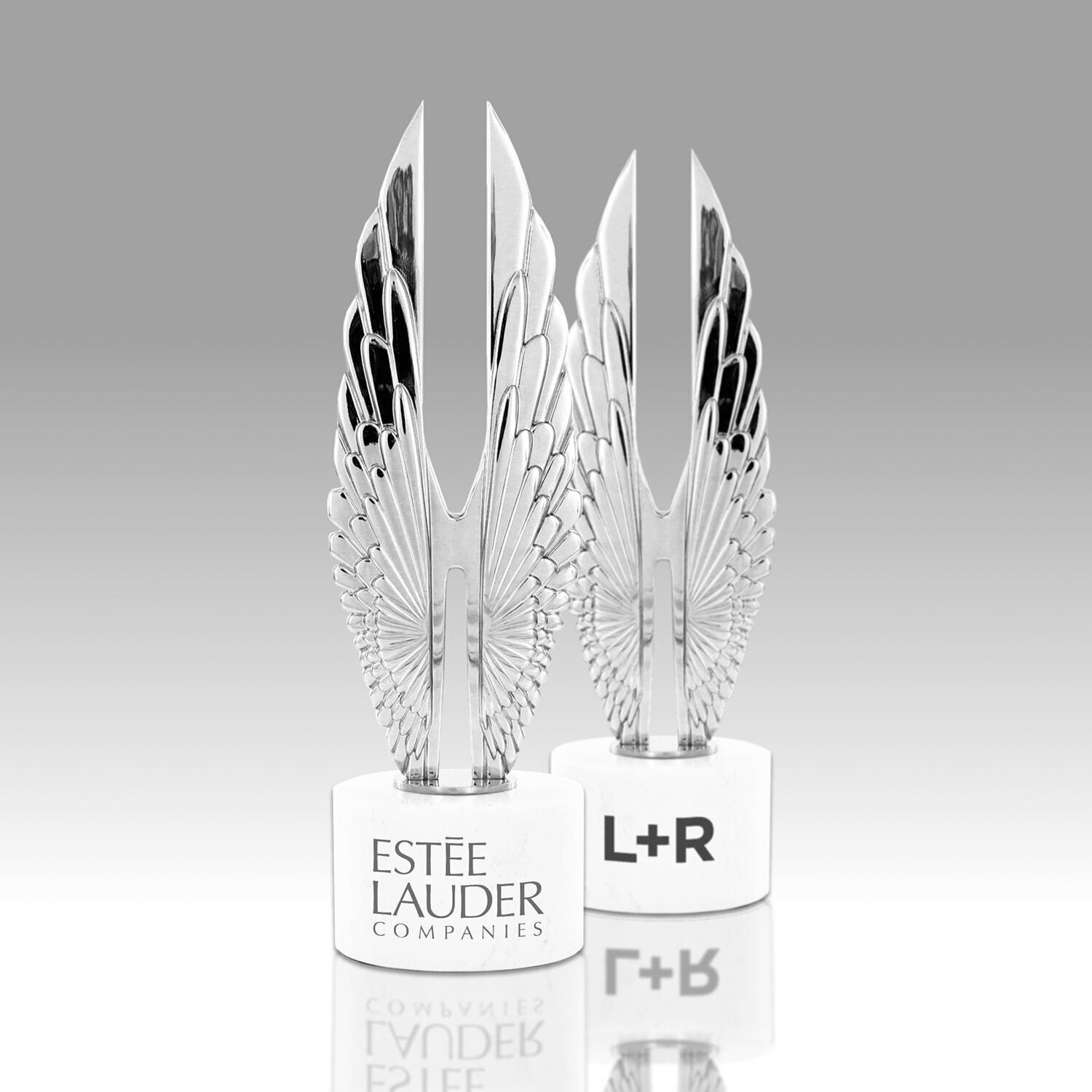 Two Hermes Creative Awards trophies labeled Estée Lauder Companies and L+R