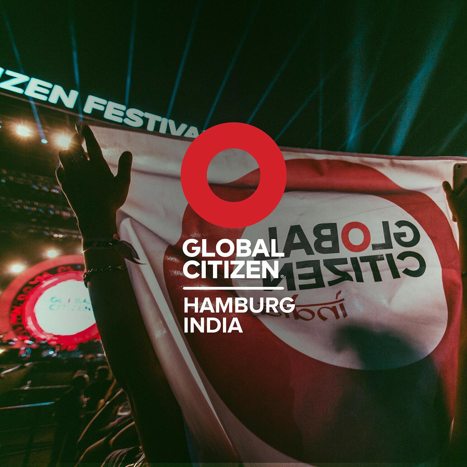 Global Citizen Hamburg India lockup over a Global Citizen Festival banner held up by the crowd