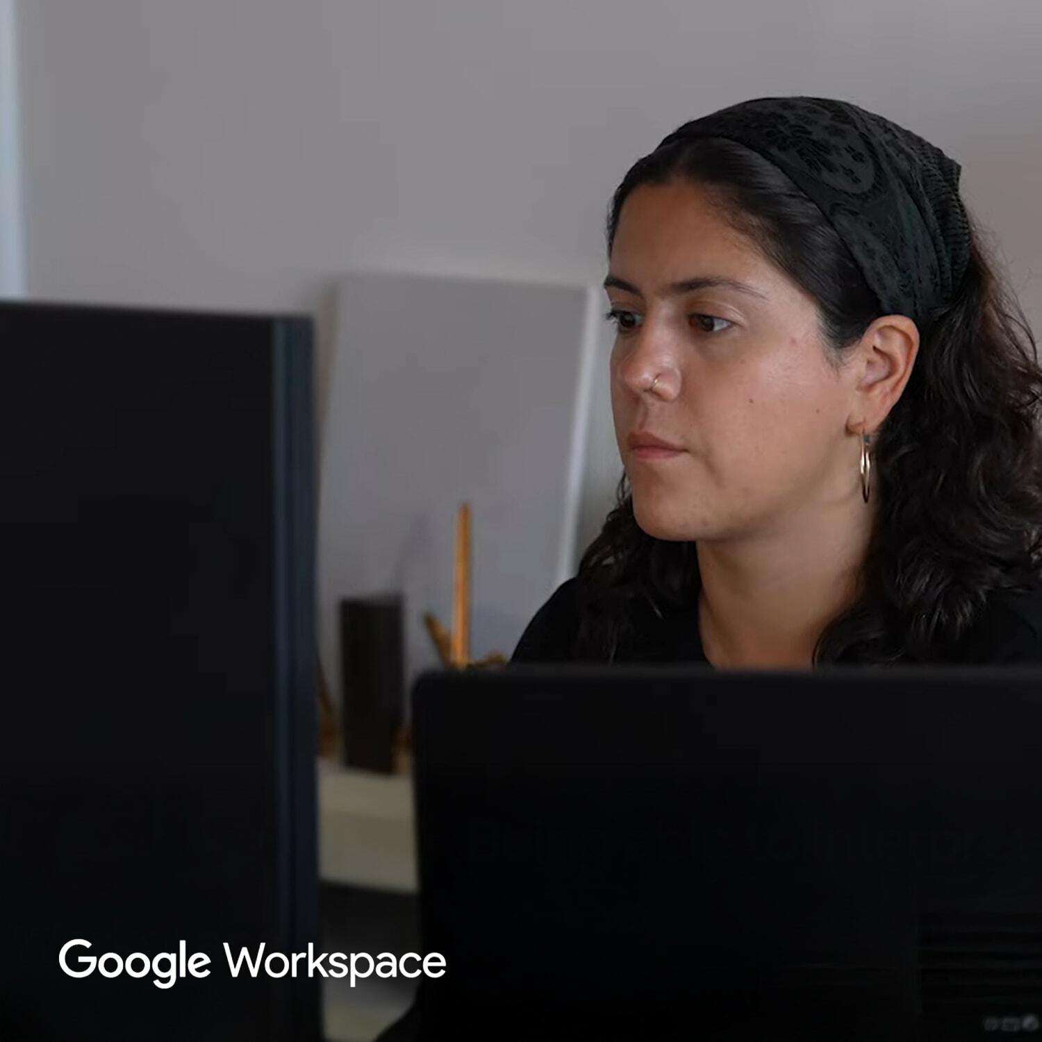 Person working at computers with Google Workspace logo