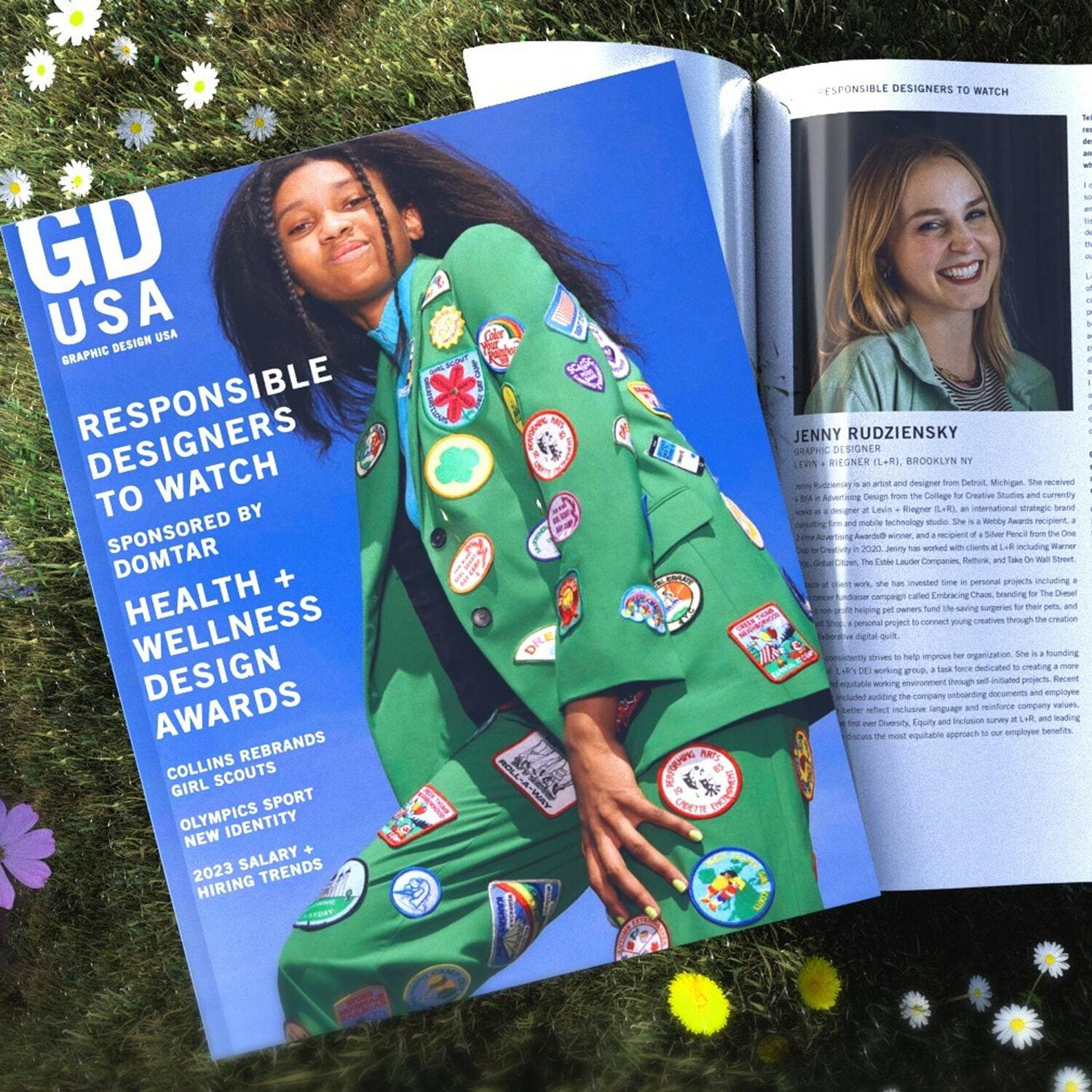 GDUSA 'Responsible Designers to Watch' issue open to Jenny Rudziensky's profile, on grass with flowers.