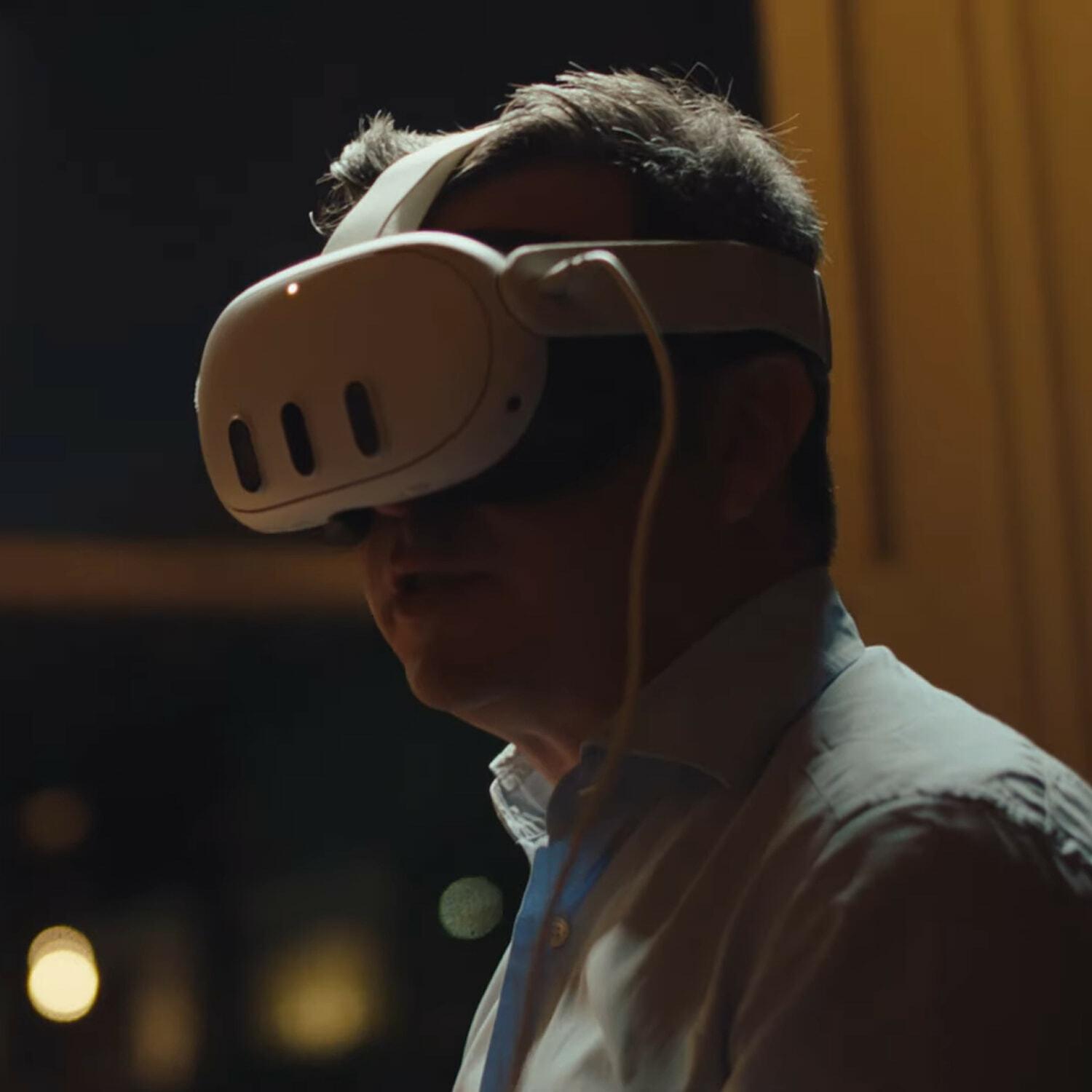 Person wearing a VR headset in dim lighting