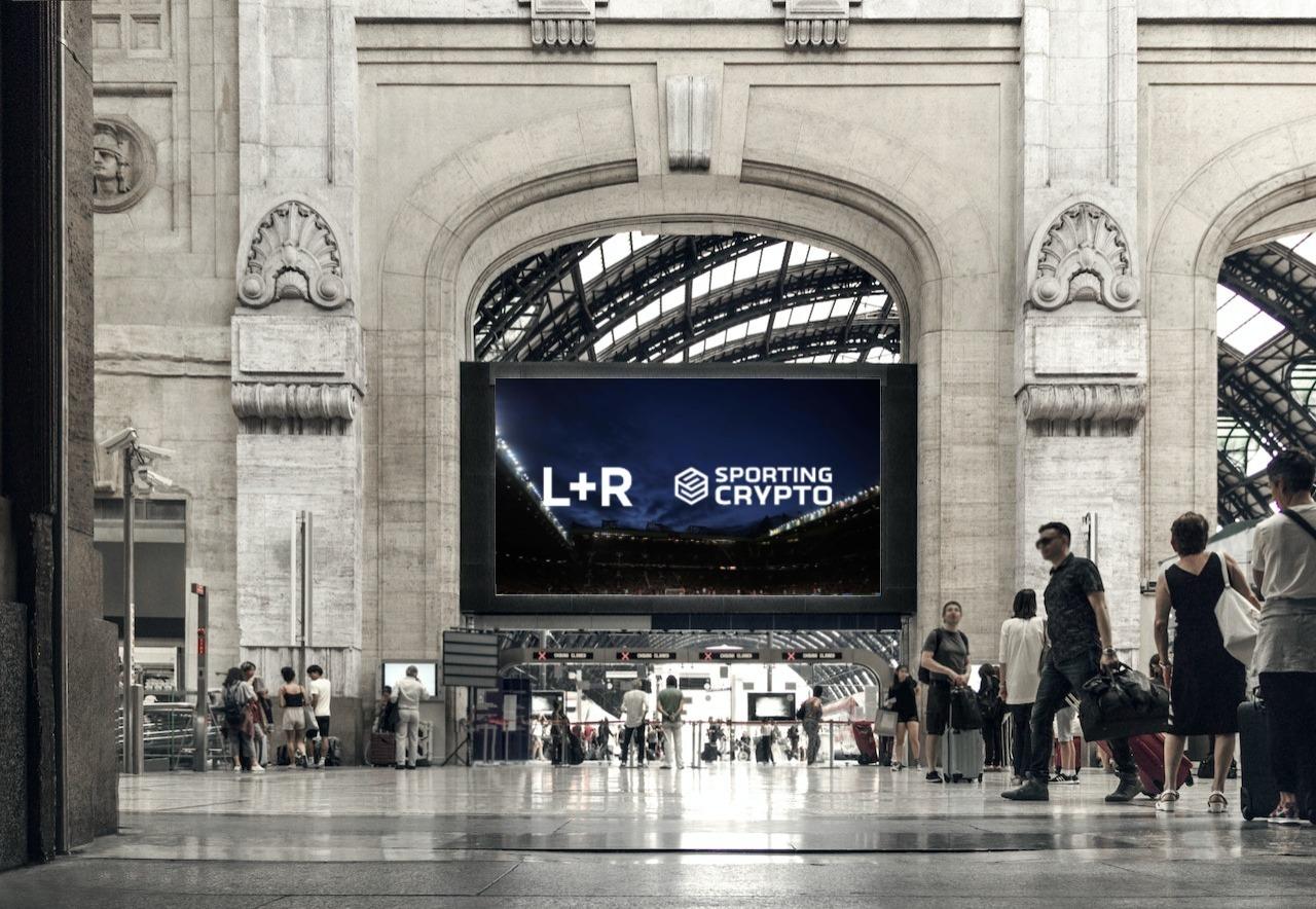 Large L+R and Sporting Crypto screen in the Milano Centrale station concourse
