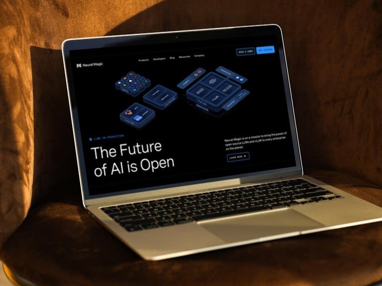 Laptop on a chair showing the Neural Magic homepage headlined "The Future of AI is Open"
