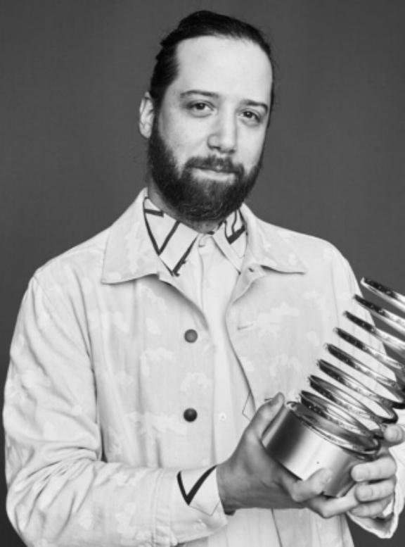 Screen Shot 2023 01 26 at 4 15 4 Black-and-white portrait of a bearded man holding a Webby Award